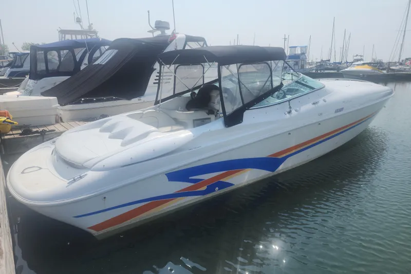 Slide: The Image of 1999 Baja 38 Special speedboat docked, featuring sleek design and vibrant graphics. - 7