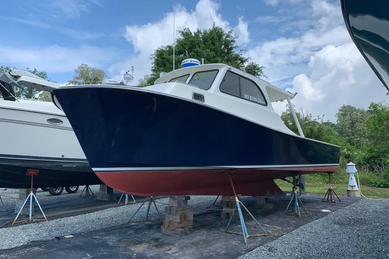 Slide: The Image of 2021 Composite Yacht CY32 Chesapeake on stands, blue hull, red bottom, outdoors. - 4