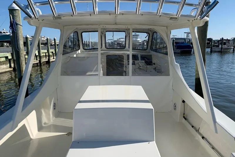Slide: The Image of 2021 Composite Yacht CY32 Chesapeake at marina, showcasing spacious deck and helm area. - 5