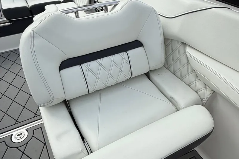 Slide: The Image of Luxurious white seating in 2021 Regal LS6 boat, featuring diamond stitching and modern design. - 10