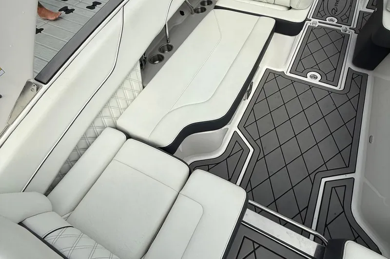 Slide: The Image of Luxurious interior of a 2021 Regal LS6 boat with white seating and patterned flooring. - 12