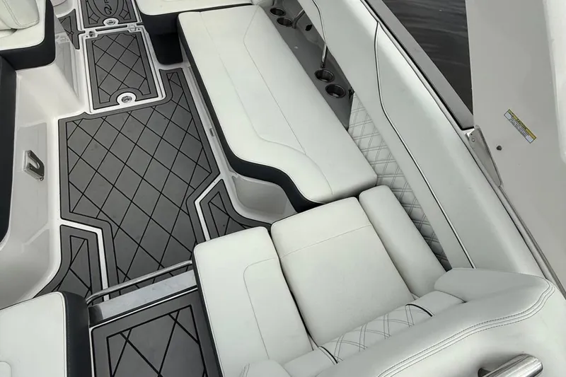 Slide: The Image of Luxurious white seating and patterned flooring in 2021 Regal LS6 boat interior. - 13