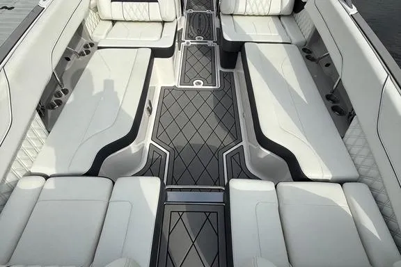 Slide: The Image of Luxurious interior of a 2021 Regal LS6 boat with white seating and diamond-patterned flooring. - 15