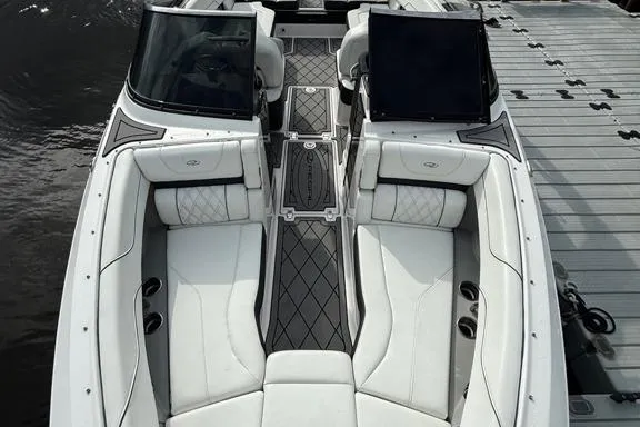 Slide: The Image of 2021 Regal LS6 boat interior with white seating and sleek design at dock. - 17