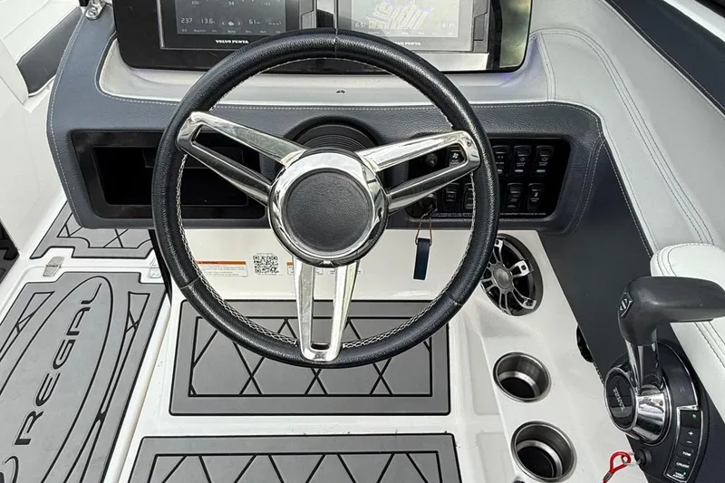 Slide: The Image of 2021 Regal LS6 boat dashboard with steering wheel and control panel. - 3