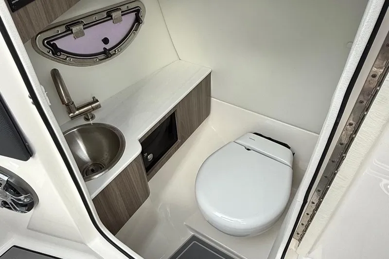 Slide: The Image of Compact bathroom in 2021 Regal LS6 boat with sink and toilet. - 8