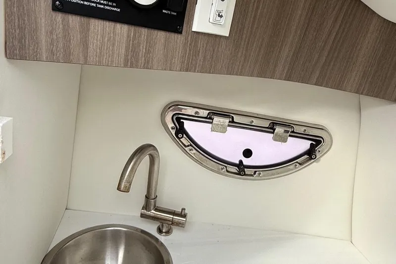 Slide: The Image of Interior of 2021 Regal LS6 boat with sink and porthole window. - 9
