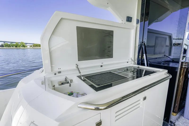 Slide: The Image of Outdoor kitchen on 2014 Sunseeker 68 Sport Yacht with grill and sink by the water. - 10