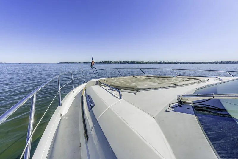 Slide: The Image of 2014 Sunseeker 68 Sport Yacht cruising on calm waters under clear blue sky. - 11