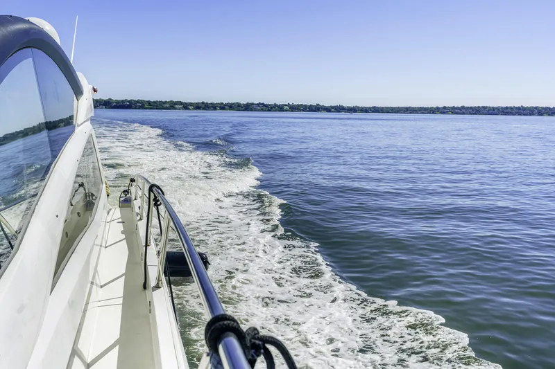 Slide: The Image of 2014 Sunseeker 68 Sport Yacht cruising on open water, clear blue sky. - 15