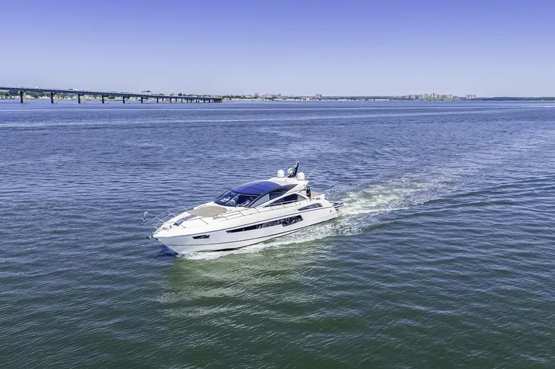 Slide: The Image of 2014 Sunseeker 68 Sport Yacht cruising on open water under clear blue sky. - 3