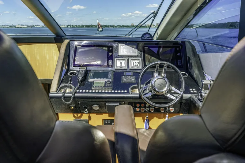 Slide: The Image of Cockpit of 2014 Sunseeker 68 Sport Yacht with steering wheel and navigation controls. - 32