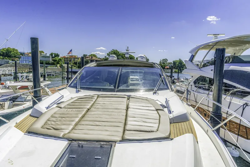 Slide: The Image of 2014 Sunseeker 68 Sport Yacht docked at marina under clear blue sky. - 33
