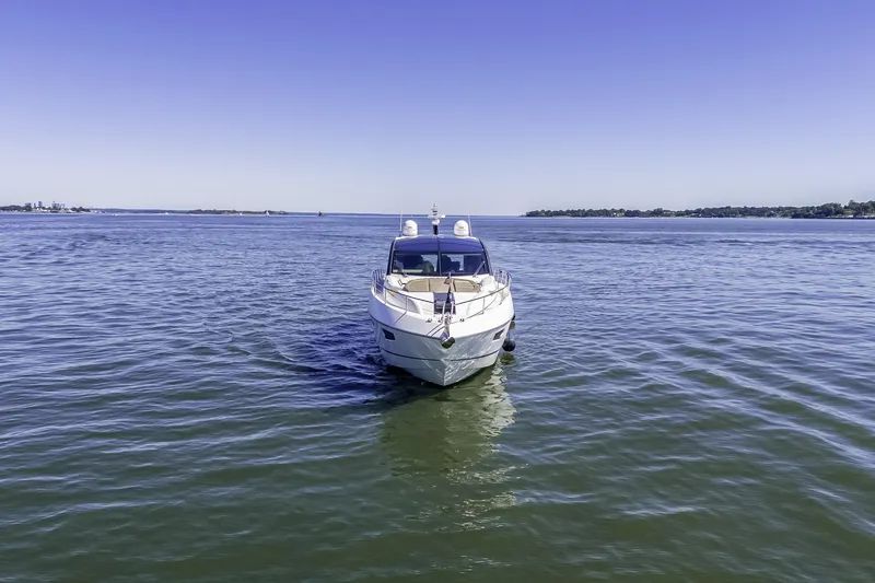 Slide: The Image of 2014 Sunseeker 68 Sport Yacht on calm blue waters under clear sky. - 4