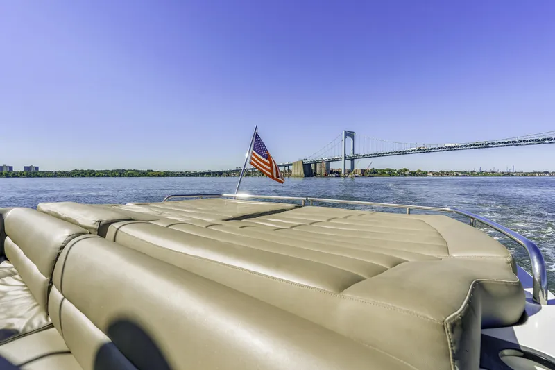 Slide: The Image of 2014 Sunseeker 68 Sport Yacht cruising near a bridge under clear blue skies. - 8