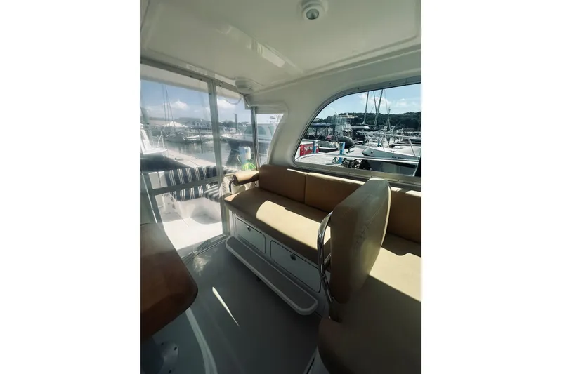 Slide: The Image of Interior of 2013 Back Cove 30 yacht with beige seating and marina view. - 27