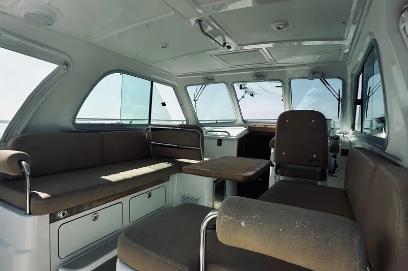 Slide: The Image of Interior of 2013 Back Cove 30 boat with seating and helm station. - 28