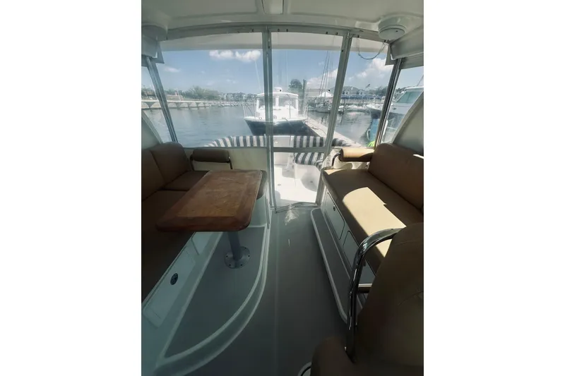 Slide: The Image of Interior view of 2013 Back Cove 30 boat with seating and table, docked at marina. - 29