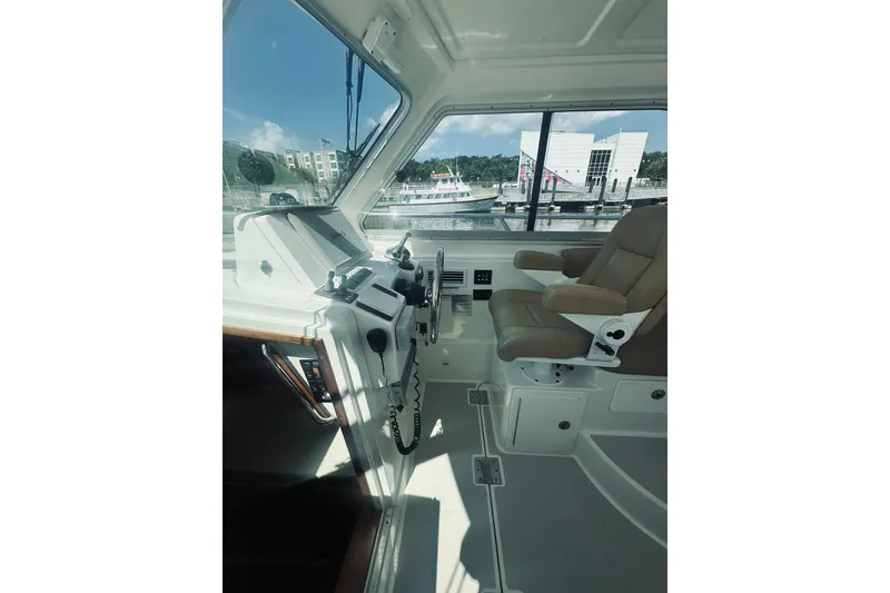 Slide: The Image of Interior of a 2013 Back Cove 30 boat, featuring helm and captain's chair. - 30