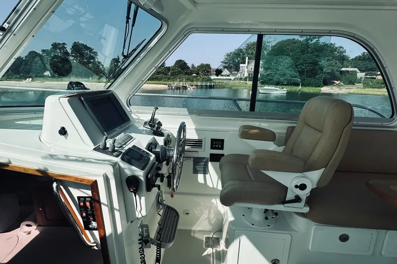 Slide: The Image of Interior of a 2013 Back Cove 30 boat with helm and captain's chair. - 32