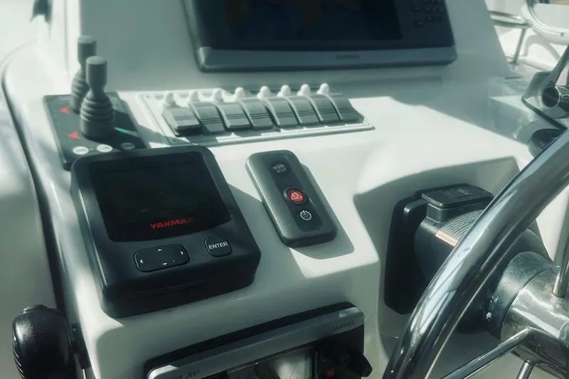 Slide: The Image of Control panel of a 2013 Back Cove 30 boat with Yanmar and Garmin displays. - 34