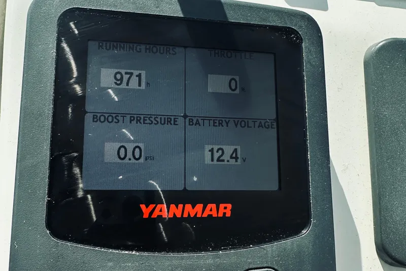 Slide: The Image of Yanmar engine display showing 971 running hours, 0% throttle, 0.0 psi boost, 12.4V battery. Back Cove 30, 2013. - 36