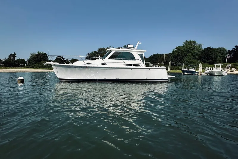 Slide: The Image of 2013 Back Cove 30 boat moored in calm waters on a sunny day. - 4