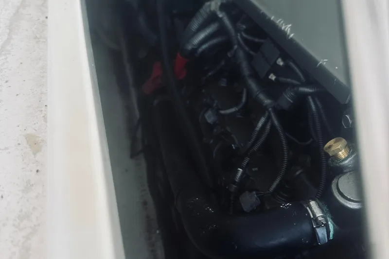 Slide: The Image of Engine compartment of a 2013 Back Cove 30 boat, showing wiring and components. - 44
