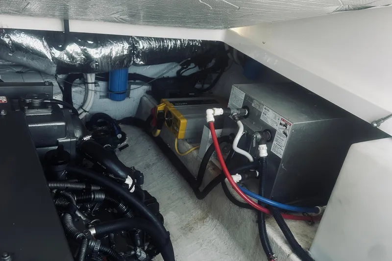 Slide: The Image of Engine compartment of a 2013 Back Cove 30 boat, showing mechanical components and wiring. - 45