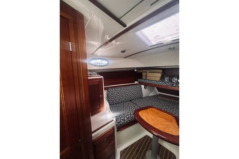Slide: The Image of 2013 Back Cove 30 cabin interior with wood finish and patterned cushions. - 50