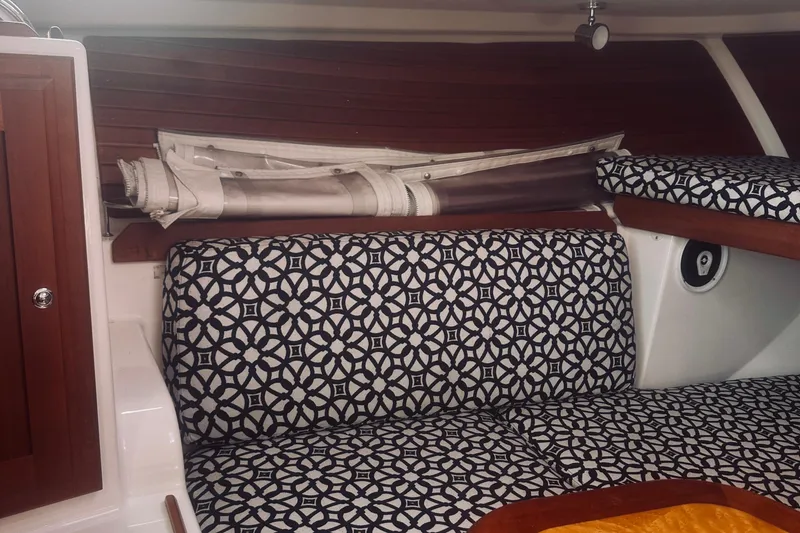 Slide: The Image of Interior of 2013 Back Cove 30 boat with patterned seating and wooden accents. - 51