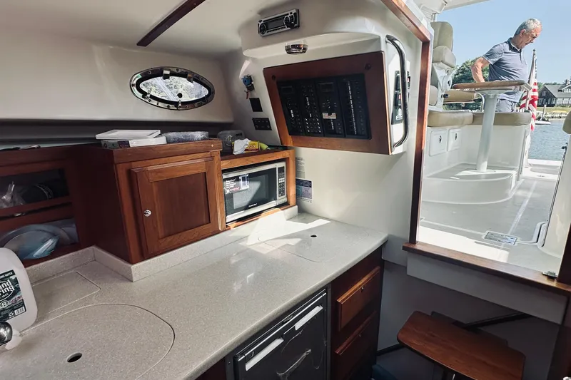 Slide: The Image of Interior of 2013 Back Cove 30 boat with kitchenette and control panel. - 55