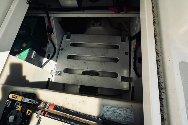 Slide: The Image of Engine compartment of a 2013 Back Cove 30 boat, showing battery and wiring. - 59
