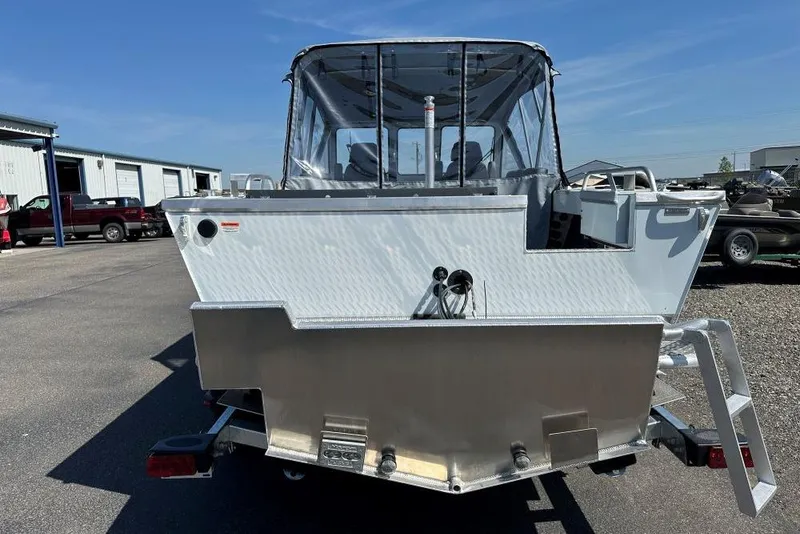 Slide: The Image of 2025 Hewescraft 190 Sea Runner ET boat, rear view, parked outdoors on a sunny day. - 4