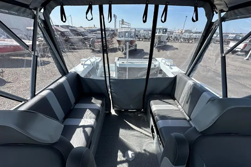 Slide: The Image of Interior view of 2025 Hewescraft 190 Sea Runner ET boat with seating and canopy. - 9