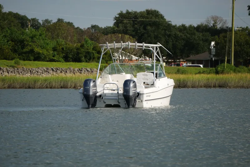 Slide: The Image of 2014 Carolina Cat 23DC boat with dual engines on a calm waterway. - 10