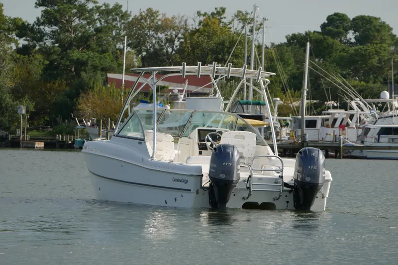 Slide: The Image of 2014 Carolina Cat 23DC boat with dual Yamaha engines on a calm waterway. - 11