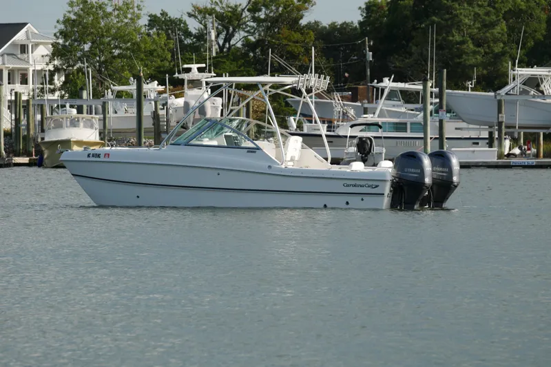 Slide: The Image of 2014 Carolina Cat 23DC boat with twin Yamaha engines on calm water. - 13