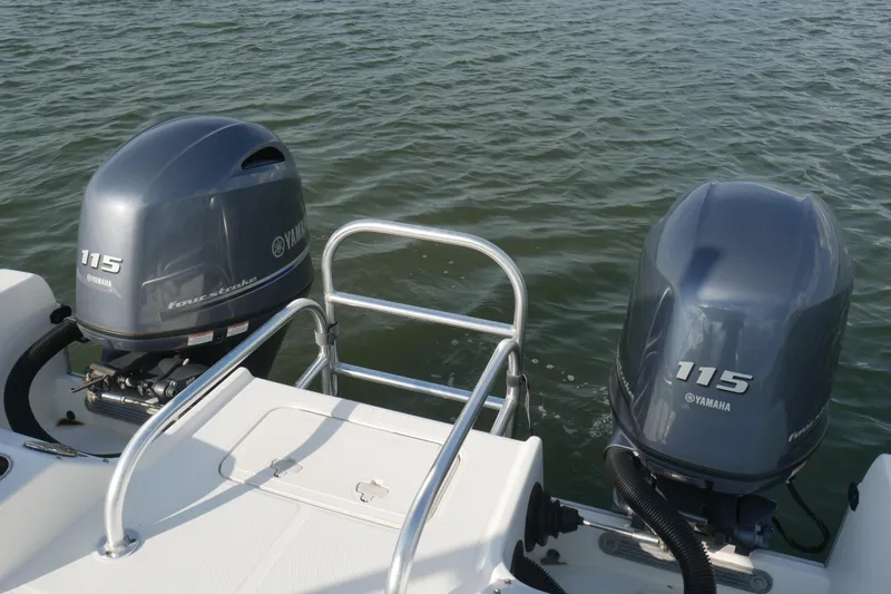 Slide: The Image of 2014 Carolina Cat 23DC boat with dual Yamaha 115 outboard motors on water. - 17