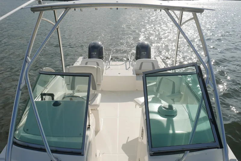 Slide: The Image of 2014 Carolina Cat 23DC boat on water, featuring dual engines and open cockpit. - 18