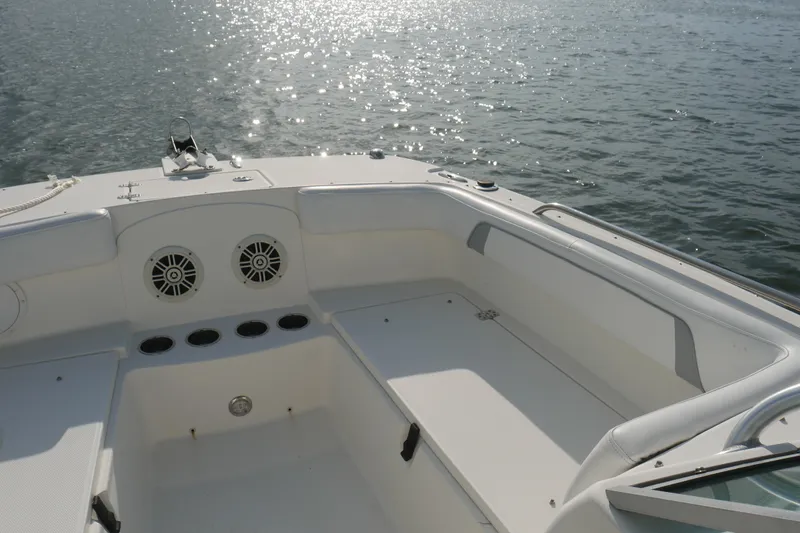 Slide: The Image of 2014 Carolina Cat 23DC boat interior with seating, on a sunny day by the water. - 21