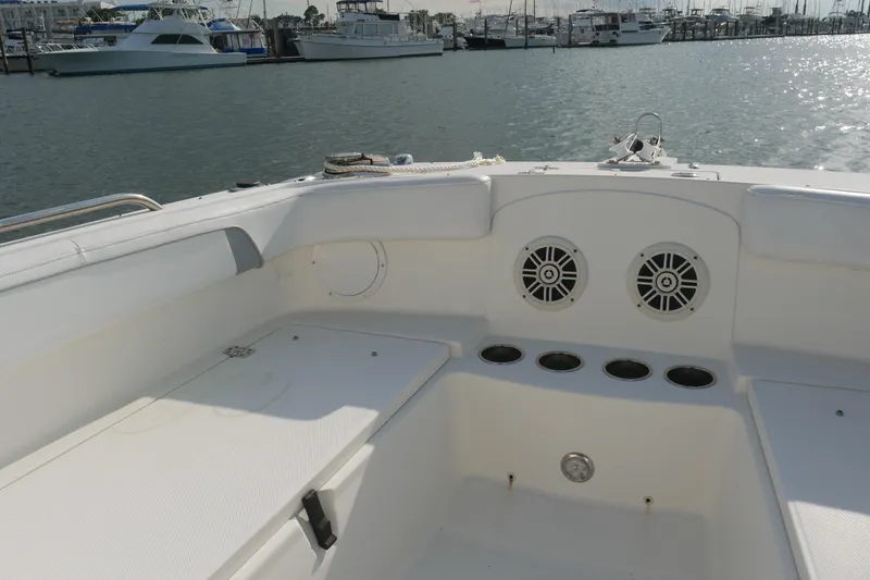 Slide: The Image of 2014 Carolina Cat 23DC boat interior with speakers, docked at marina. - 22