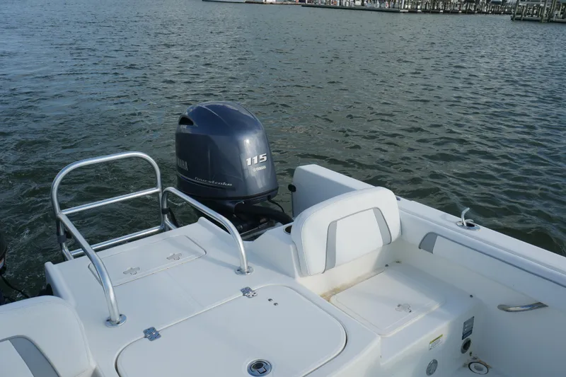 Slide: The Image of 2014 Carolina Cat 23DC boat with Yamaha 115 outboard motor on water. - 27