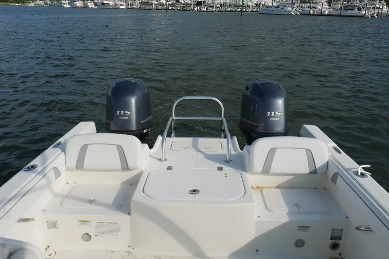 Slide: The Image of 2014 Carolina Cat 23DC boat with twin Yamaha 115 engines on calm water. - 28