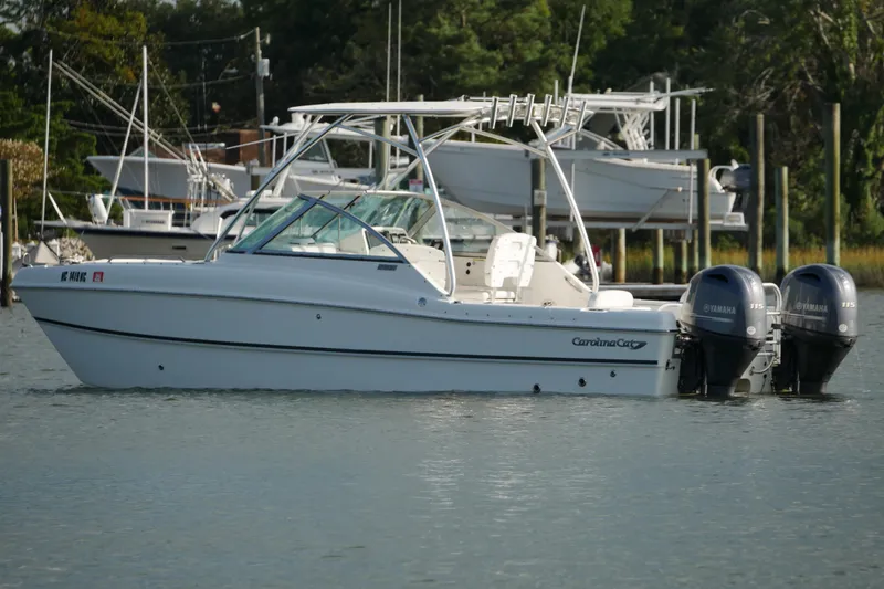 Slide: The Image of 2014 Carolina Cat 23DC boat with dual Yamaha engines on calm water. - 3