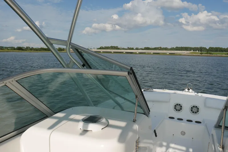 Slide: The Image of 2014 Carolina Cat 23DC boat on water, featuring open deck and clear skies. - 30
