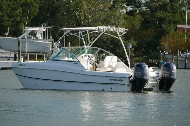 Slide: The Image of 2014 Carolina Cat 23DC boat with dual Yamaha engines on calm water. - 5