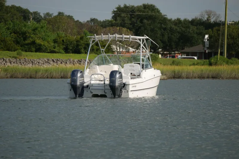 Slide: The Image of 2014 Carolina Cat 23DC boat with dual engines on a calm waterway. - 9