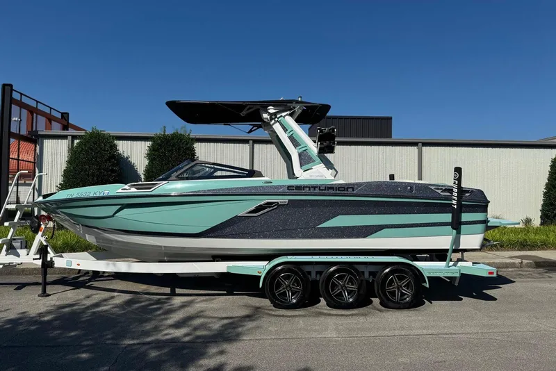 The Image of 2021 Centurion Ri245 boat on trailer, sleek design, mint and black color scheme. - 0
