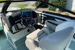 Slide: The Image of Luxurious interior of 2021 Centurion Ri245 boat with teal and gray seating. - 11